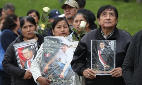 Supporters of the late former Peruvian president Alberto Fujimori wait in line to attend his wake in Lima, Peru.