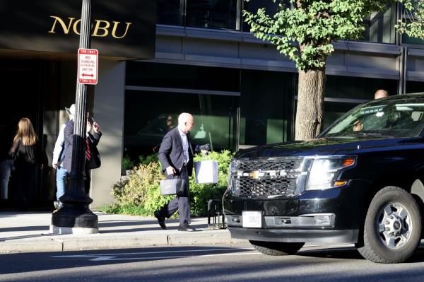 Washington , DC, October 10th 2024.
United States Secretary of Homeland Security, Alejandro Mayorkas pics up two bags of take away food from high end restaurant Nobu.